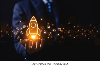 The hand shows a rocket and an icon. Concept of Startup Business, Entrepreneurship Idea, and Online Digital Business. network connection on the interface Marketing, Technology, and Success