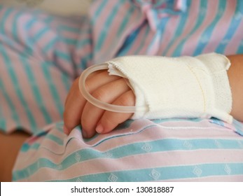 Hand Of Sick Little Girl In Hospital Bed