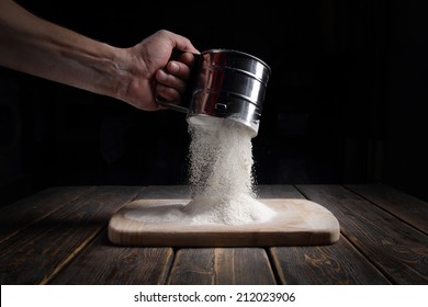 Hand Sifts The Flour Through A Sieve.