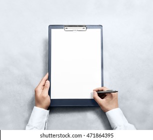 Hand signing blank clipboard with white a4 paper design mockup. Clear document holder mock up template hold arm. Clip board notepad surface display front. Checklist tablet plan file presentation. - Powered by Shutterstock