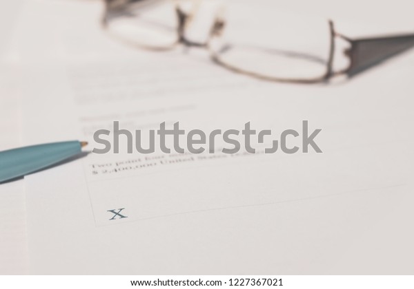 Hand signing legal contract for gaining\
ownership of company.  Binding legal\
contract.
