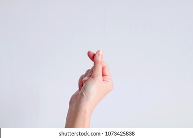 A Hand Signs Gesture To Be Little Heart From Tip Of Thumb And Index Finger On White Background.