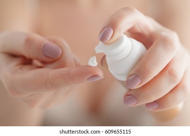 Hand Skin Care. Close Up Of Female Hands Holding Cream Tube, Beautiful Woman Hands With Natural Manicure Nails Applying Cosmetic Hand Cream On Soft Silky Healthy Skin. Beauty And Body Care Concept