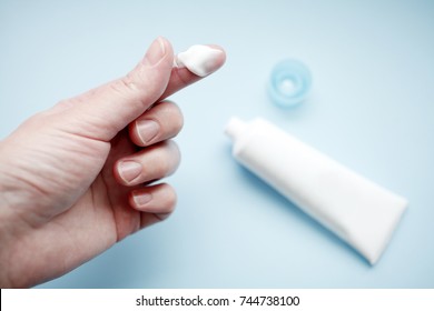 Hand Skin Care. Close Up Of Female Hands Holding Cream Tube, Beautiful Woman Hands With Natural Manicure Nails Applying Cosmetic Hand Cream On Soft Silky Healthy Skin. Beauty And Body Care Concept - Powered by Shutterstock