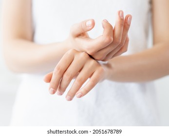 Hand skincare. Moisturizing cosmetology. Skin protection. Closeup of woman gentle palms smearing soothing cream product at white background.