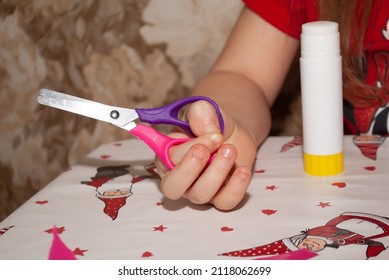 Hand Of A Small Child Holding Scissors Craft In Kindergarten