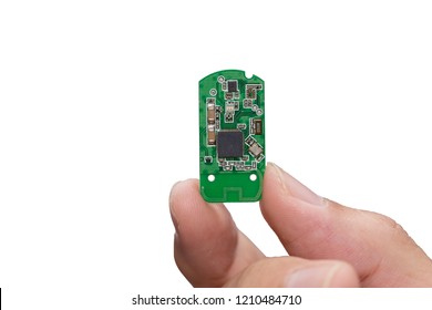 hand with small electronic microchip microcontroller isolated on white background.