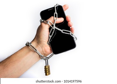 hand and smartphone are connected with an iron chain with lock on white background. social media and Internet addiction.