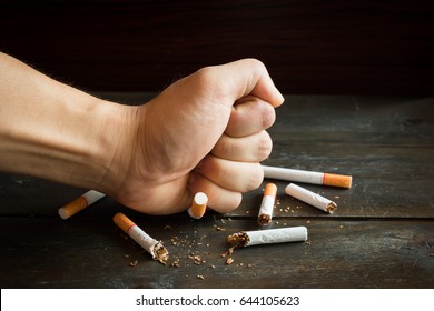 Hand smash for destroy many tobaccoes concecpt no smoke forever.