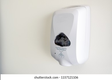 Hand soap dispenser mounted on the wall.