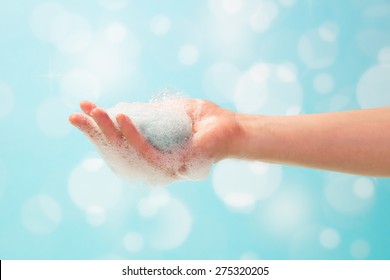 Hand And Soap Foam On A Blue Background