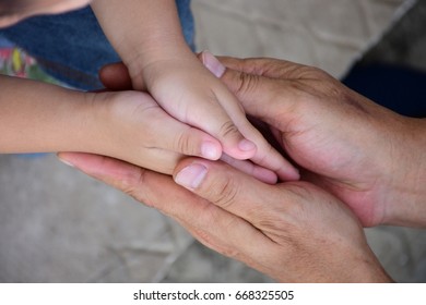 The hand of son is hold by his father with love and care - Powered by Shutterstock