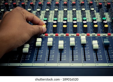 The hand of  sound engineer  on mixing  controller.