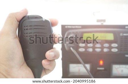 Hand with speakerphone with radio transceiver base station.