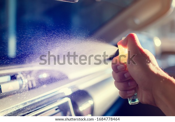 Hand spraying alcohol,disinfectant on  Air\
conditioner in her car,prevent infection of\
Covid19,Coronavirus,nCoV,contamination of germ,bacteria,wipe clean\
surfaces that are frequently\
touch