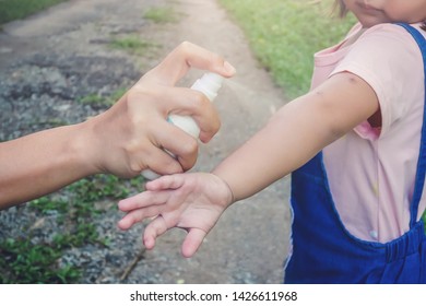 Hand spraying insect or mosquito repellents on skin girl, mosquito repellent for babies, toddlers that will protect your children from mosquitoes and other insects