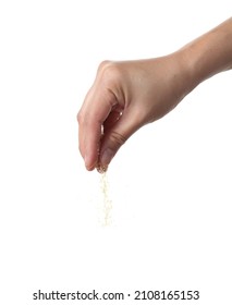 Hand Sprinkling Brown Sugar Isolated On Black Background