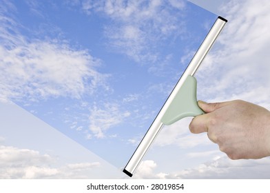 hand with a squeegee turning dull sky into blue - Shutterstock ID 28019854