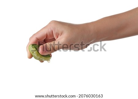 Hand squeeze green lime isolated on white background