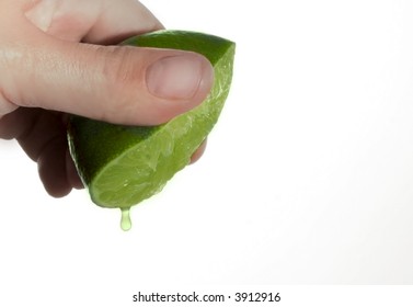 Hand Squeezing A Drop Of Lime Juice