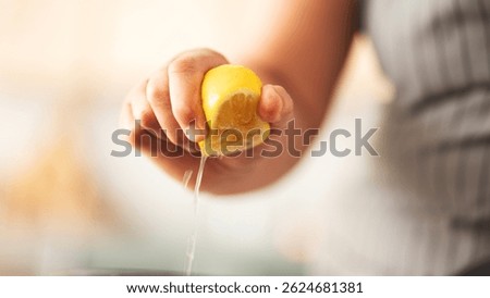 Hand squeezing lemon close up view