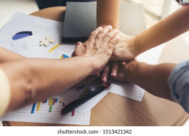 Hand stack and hold together with several hands in team for sccess something of business or take care.expresses the unity,concern and joy of teamwork.