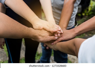 Hand stack and hold together in team for success something or take care.