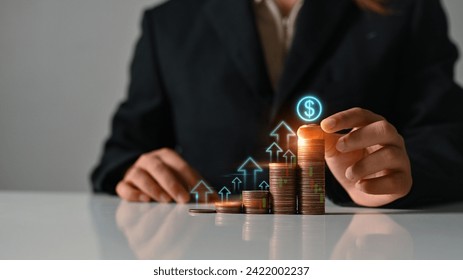 Hand stacking coin with different heights up arrow icons. long term investment, Interest rat and financial growth concept - Powered by Shutterstock