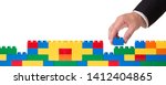 hand stacking a plastic block