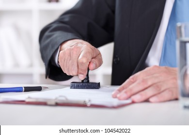 ManÃ¢Â?Â?s Hand Stamping Documents, Close-up