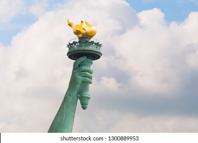 Hand of Statue of Liberty with cloudy background - Powered by Shutterstock