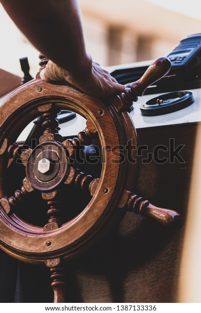 A Hand steering boat\
wheel