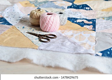 Hand Stitch Quilting Process: Cotton Thread, Needle And Scissors On The Table