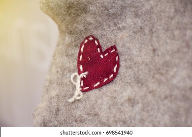 Hand Stitch Of The Red Heart Of Wool Fabric To The Wool Gray Color.  The Symbol Of Love And Valentine Day. The Art Of Love For The Love One, Nice Give For Some One Special. 