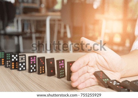 hand stop continuous toppled. prevent chain reaction domino effect. risk, failure, solution & strategy in business.