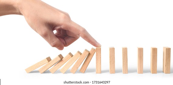 Hand stopping the Domino effect stopped by unique, Business Ideas