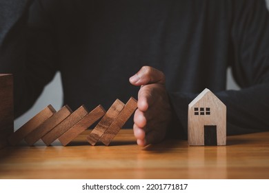 Hand Stopping The Domino Safe House Crisis Effect Or Risk Plan Real Estate Protection, Business Solution And Intervention, Wooden Tower Falling Concept.