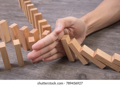 Hand Stopping Wooden Block Domino. Concept Prevent And Solution.