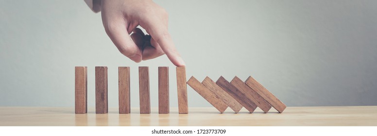 Hand Stopping Wooden Domino Business Crisis Effect Or Risk Protection Concept