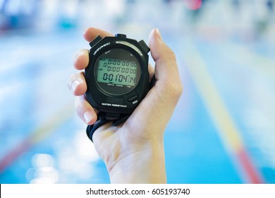 hand  with a stopwatch during competitions in the swimming pool

