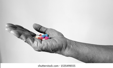 Hand with substances or drugs. 
Drug abuse may intoxication, addiction and alter physical control. Illegal substance as cannabis, cocaine, amphetamine, heroin, hallucinogen, methaqualone, or opioid. 