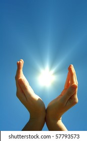 Hand Sun And Blue Sky With Copyspace Showing Freedom Or Solar Power Concept