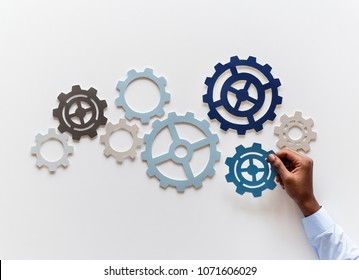 Hand with support gears isolated on white background - Shutterstock ID 1071606029