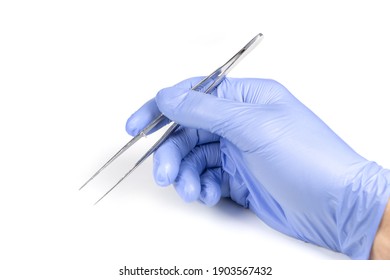 Hand Of Surgeon In Blue Medical Glove Holding A Tweezers Isolated On White Background,