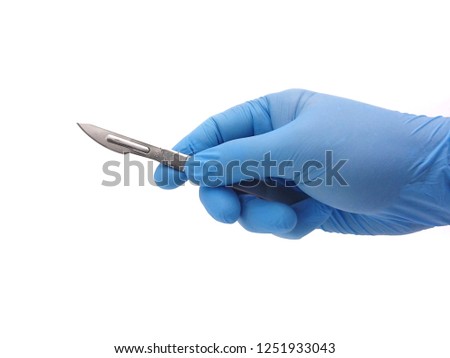 Hand of surgeon in blue medical glove holding a scalpel isolated on white background
