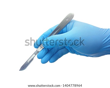 Hand of surgeon in blue medical glove holding a scalpel with blade isolated on white background with clipping path