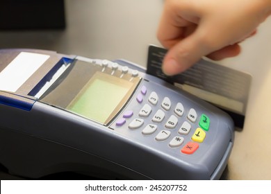 Hand Swiping Credit Card In Store