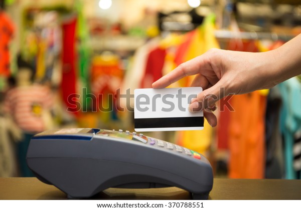 Hand Swiping Credit Card In\
Store