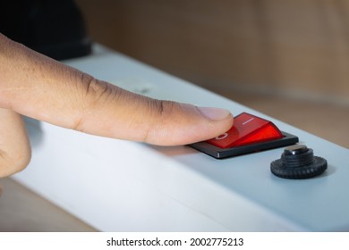 Hand Is Switching Off A Plug Socket For Energy Saving.