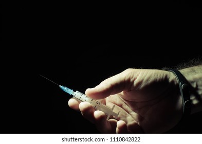 hand with syringe - Shutterstock ID 1110842822